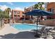 Resort-style pool with lounge chairs and umbrellas, perfect for relaxation at 59 E Agate Ave # 306, Las Vegas, NV 89123