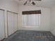 Neutral bedroom featuring a ceiling fan, carpet, and double door closet at 5912 Wabusca Way, Las Vegas, NV 89142
