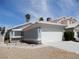 Charming one-story home with a two-car garage, desert landscaping, and a blue sky at 5912 Wabusca Way, Las Vegas, NV 89142