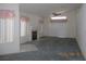 Bright living room with high ceilings, fireplace, carpet, and a large window at 5912 Wabusca Way, Las Vegas, NV 89142