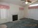 Open living room featuring a cozy fireplace, ceiling fan, and natural light at 5912 Wabusca Way, Las Vegas, NV 89142