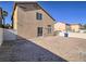 Spacious backyard features dirt landscaping with the rear of the house in view at 5929 Sleepy Fawn Dr, Las Vegas, NV 89142