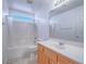 Bathroom boasts tile floors, a shower-tub combo and single sink vanity at 5929 Sleepy Fawn Dr, Las Vegas, NV 89142