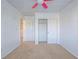Carpeted bedroom featuring a closet, a ceiling fan, and neutral walls at 5929 Sleepy Fawn Dr, Las Vegas, NV 89142