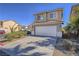 Charming two-story home features a two car garage, desert landscaping and tile roof at 5929 Sleepy Fawn Dr, Las Vegas, NV 89142