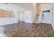 Open-concept living room features hardwood floors, staircase and access to a kitchen with wood cabinets at 5929 Sleepy Fawn Dr, Las Vegas, NV 89142