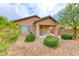 This home features a charming backyard with tasteful landscaping and a covered patio at 6116 Tokara Ave, Las Vegas, NV 89122