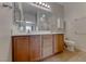 Bathroom featuring double sinks, tile floors and a large well lit mirror at 6116 Tokara Ave, Las Vegas, NV 89122