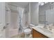 A bathroom features a vanity, toilet, and shower-tub combo with a patterned shower curtain at 6116 Tokara Ave, Las Vegas, NV 89122