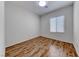 This bright bedroom boasts sleek laminate flooring and a well-lit window at 6116 Tokara Ave, Las Vegas, NV 89122