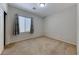 Empty bedroom with neutral walls, carpet, and a window for natural light at 6116 Tokara Ave, Las Vegas, NV 89122
