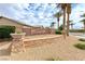 Welcoming community entrance with stone signage and desert landscaping at 6116 Tokara Ave, Las Vegas, NV 89122