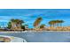 Well-maintained community entrance with lush palm trees and desert landscaping at 6116 Tokara Ave, Las Vegas, NV 89122