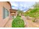 Side view of a tan home with meticulous rock landscaping with a covered patio at 6116 Tokara Ave, Las Vegas, NV 89122