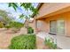 A view of the home's exterior featuring a small covered patio and well-maintained landscaping at 6116 Tokara Ave, Las Vegas, NV 89122