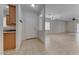 Bright foyer with tile flooring, coat hooks, and an open floor plan leading to the living area at 6116 Tokara Ave, Las Vegas, NV 89122
