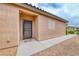 Close up view of front door with a security door frame, concrete walkway and desert rock landscaping at 6116 Tokara Ave, Las Vegas, NV 89122