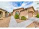 Well-kept single story home with desert landscaping and a two car garage and beautiful desert plants at 6116 Tokara Ave, Las Vegas, NV 89122