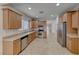 Open kitchen features stainless steel appliances and wooden cabinets at 6116 Tokara Ave, Las Vegas, NV 89122