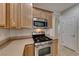 Kitchen with stainless steel microwave and gas range at 6116 Tokara Ave, Las Vegas, NV 89122