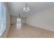 Living room features tile floors, sliding door to backyard, and neutral walls at 6116 Tokara Ave, Las Vegas, NV 89122