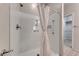 Bright white shower with curtain and shelves, connected to a storage closet at 6116 Tokara Ave, Las Vegas, NV 89122