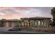 Charming single story home boasting a terracotta roof, stone accents, and desert landscaping at 64 Tapadero Ln, Las Vegas, NV 89135