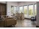 Bright living room with large windows, a view of the backyard, and a cozy sitting area for enjoying the outdoors at 64 Tapadero Ln, Las Vegas, NV 89135