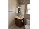 Single vanity bathroom featuring wood cabinet, tile floor, and large mirror at 6495 Chettle House Ln, Las Vegas, NV 89122