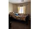Comfortable bedroom with colorful decor and a window for natural light at 6495 Chettle House Ln, Las Vegas, NV 89122