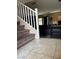 Open entryway to the home featuring neutral tile floors, and stairs with plush carpet at 6495 Chettle House Ln, Las Vegas, NV 89122