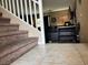 Inviting entryway with tiled floor, carpeted stairs and railing leading to the living area at 6495 Chettle House Ln, Las Vegas, NV 89122