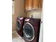 Efficient laundry area showcasing modern machines, cabinets, and ample space for all laundry needs at 6495 Chettle House Ln, Las Vegas, NV 89122