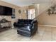 Living room featuring modern tile floors, contemporary leather sofa, and neutral wall colors at 6495 Chettle House Ln, Las Vegas, NV 89122
