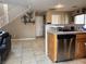 Open concept living space with stairs, dishwasher, and tile flooring at 6495 Chettle House Ln, Las Vegas, NV 89122