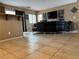 Cozy living room with a large sofa, mounted TV, and neutral color palette at 6495 Chettle House Ln, Las Vegas, NV 89122