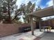 Comfortable outdoor patio with a covered area and mature trees at 6495 Chettle House Ln, Las Vegas, NV 89122