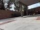 Charming covered patio with brick accents and ample seating at 6495 Chettle House Ln, Las Vegas, NV 89122