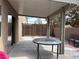 Charming covered patio with brick accents and an outdoor dining area at 6495 Chettle House Ln, Las Vegas, NV 89122