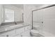 Modern bathroom features a sleek vanity with solid surface counters and a glass-enclosed shower at 6760 Violet Cascade Ave, Las Vegas, NV 89156