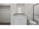 Neutral bathroom includes a vanity with solid surface counters, a large mirror and a shower at 6760 Violet Cascade Ave, Las Vegas, NV 89156