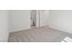 Bright bedroom boasts neutral walls, carpet floors, and an adjacent bathroom for added convenience at 6760 Violet Cascade Ave, Las Vegas, NV 89156