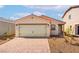 Charming single-story home with a two-car garage, landscaped with a brick driveway and desert plants at 6760 Violet Cascade Ave, Las Vegas, NV 89156