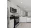 Bright kitchen featuring white cabinetry, stainless steel appliances and a grey countertop at 6760 Violet Cascade Ave, Las Vegas, NV 89156
