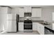 Modern kitchen with stainless steel appliances, white cabinets and plenty of countertop space at 6760 Violet Cascade Ave, Las Vegas, NV 89156