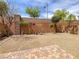 Low maintenance backyard featuring stone, small trees, and brick perimeter wall at 7011 Overton St, Las Vegas, NV 89166