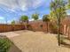 Low maintenance backyard featuring stone, small trees, brick perimeter wall, and blue sky at 7011 Overton St, Las Vegas, NV 89166
