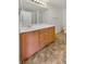 Bathroom features a vanity with drawers and cabinet, along with tile flooring at 7011 Overton St, Las Vegas, NV 89166