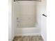 Bathroom featuring a tub/shower combo with white tiling and chrome fixtures at 7011 Overton St, Las Vegas, NV 89166