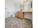 Bathroom with a vanity, large mirror, tile flooring, toilet, and modern fixtures at 7011 Overton St, Las Vegas, NV 89166